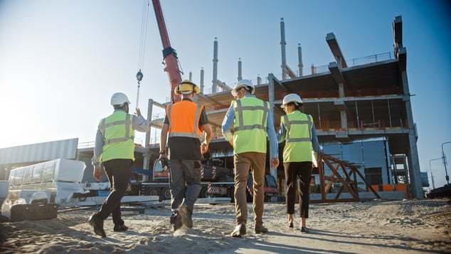 Group of business employees looking at a new property build 