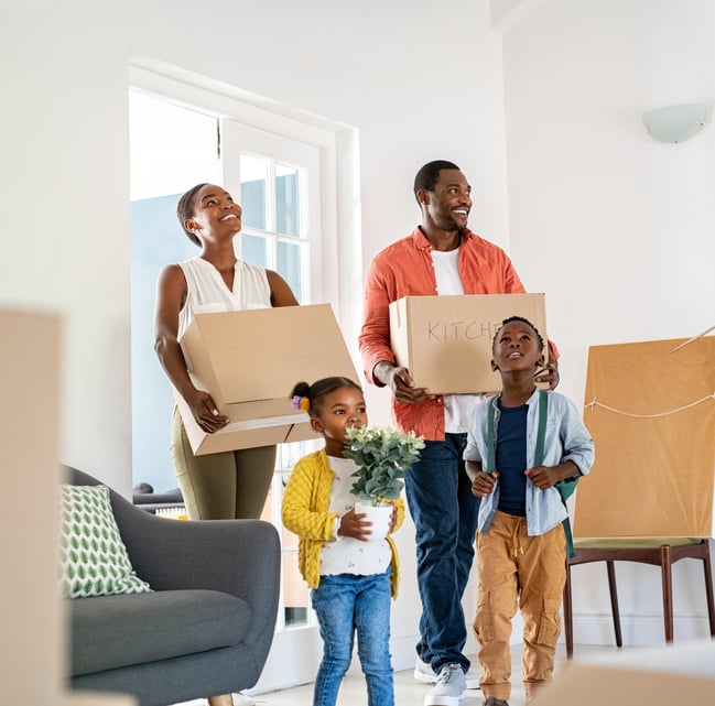 Black family moving in with boxes to their new home
